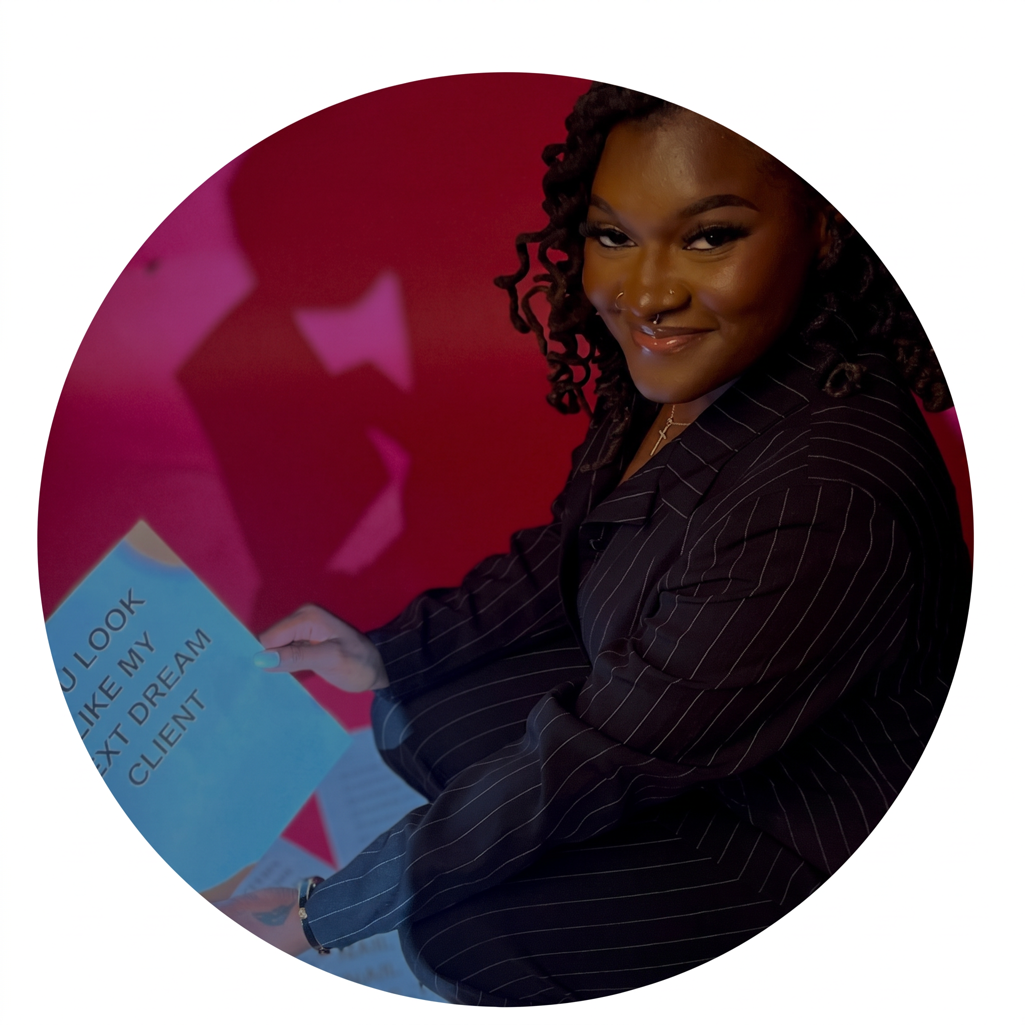 Malishia, licensed nail technician and owner of Serenity Sole Spa, seated in her studio holding a card